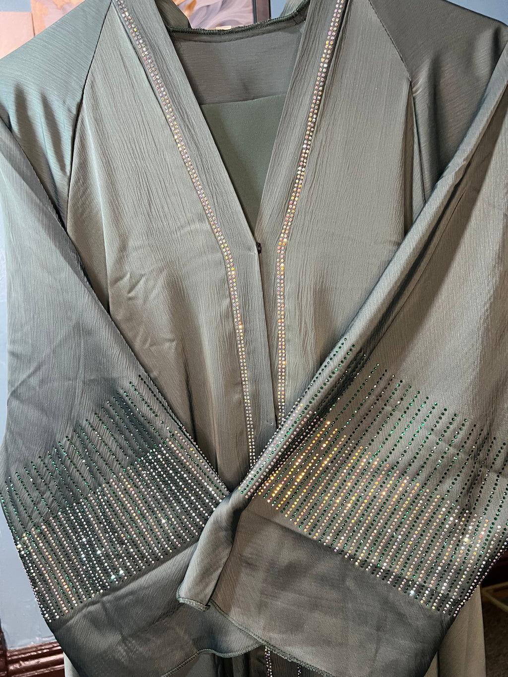 Teal-colored abaya with intricate rhinestone