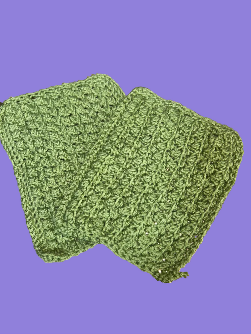 2 handmade crocheted green washcloths.