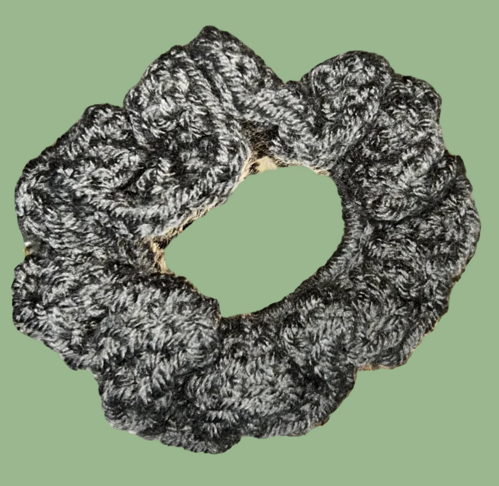 Set of 4 handmade crocheted scrunchies in various colors.