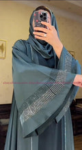 Teal-colored abaya with intricate rhinestone