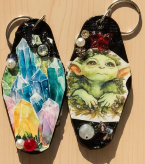 2 retro motel key rings decorated with costume jewelry & decoupage.