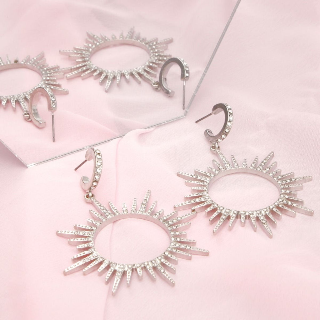 Silver Drop Hoop Earrings with Sunburst Rhinestone Detail – Stylish Statement Jewelry